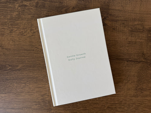 Hot Girls Are Vegan Daily Journal displayed on a brown table